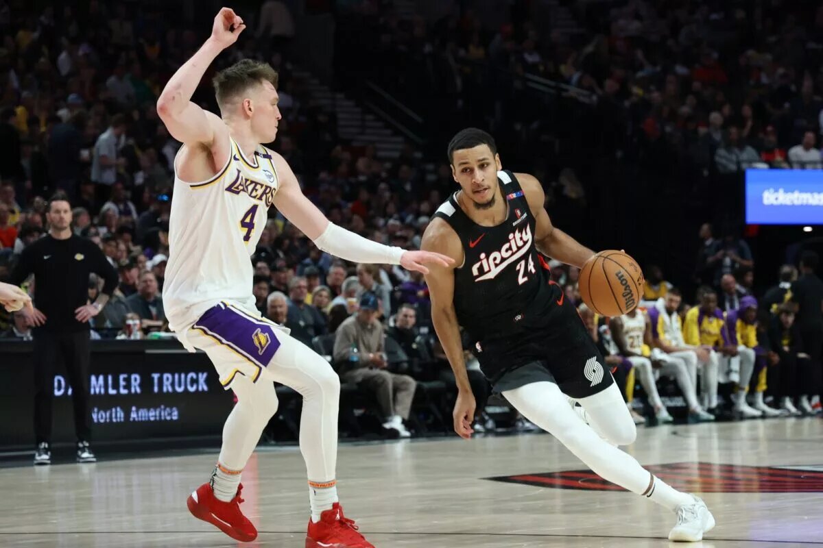 Apr 13, 2025; Portland, Oregon, USA; Portland Trail Blazers forward Kris Murray (24) dribbles the ball past Los Angeles Lakers guard Dalton Knecht (4) in the first half at Moda Center. Mandatory Credit: Jaime Valdez-Imagn Images