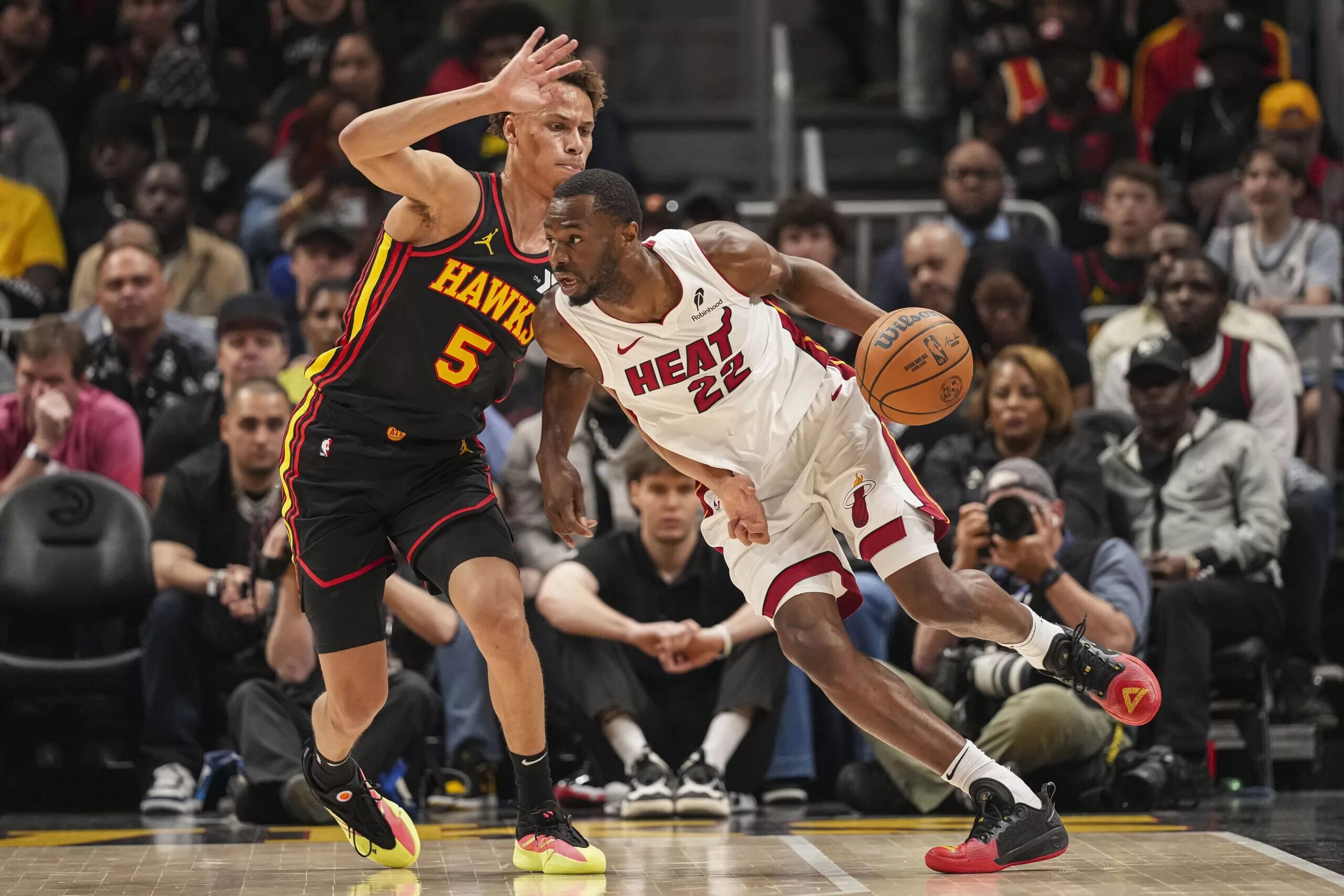 Apr 18, 2025; Atlanta, Georgia, USA; Miami Heat forward Andrew Wiggins (22) dribbles against Atlanta Hawks guard Dyson Daniels (5) during the first half at State Farm Arena. Mandatory Credit: Dale Zanine-Imagn Images