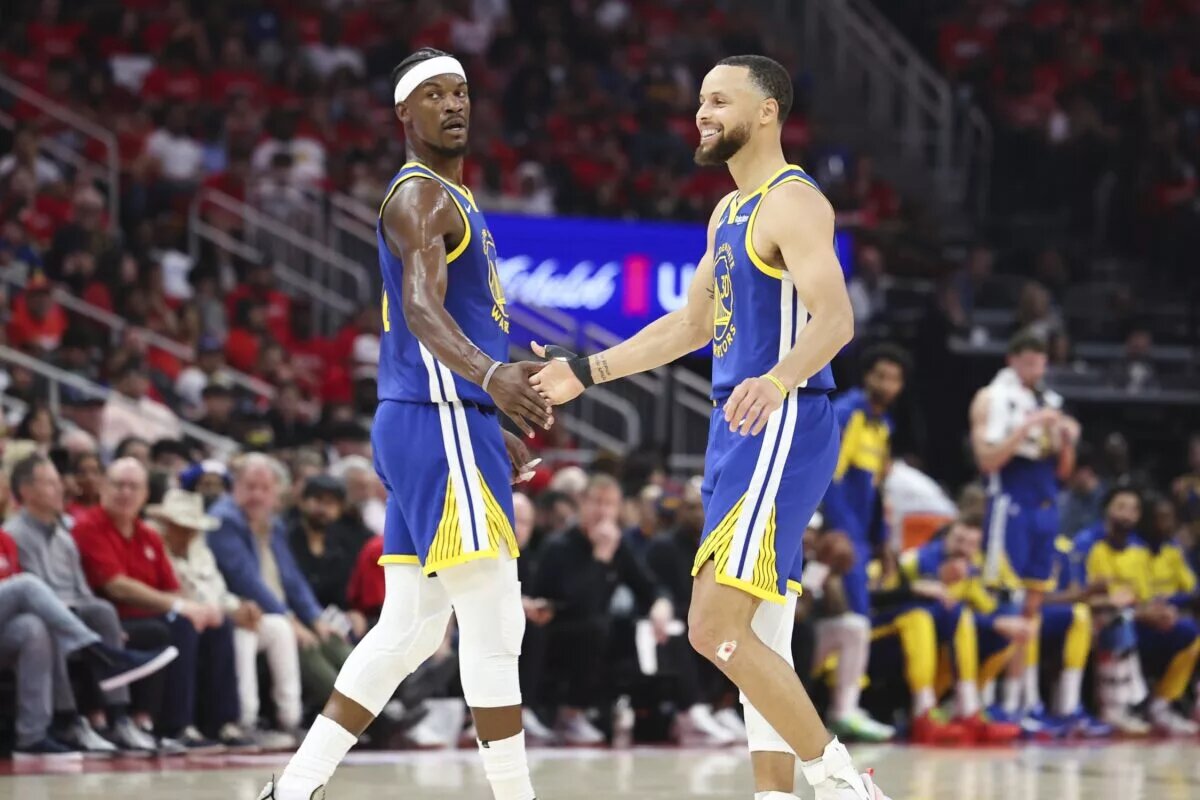 Golden State Warriors guard Stephen Curry (30) celebrates with forward Jimmy Butler III
