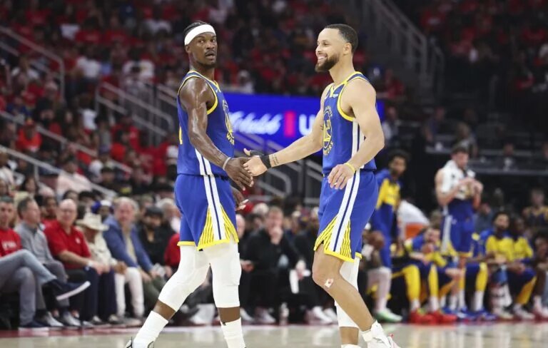 Golden State Warriors guard Stephen Curry (30) celebrates with forward Jimmy Butler III