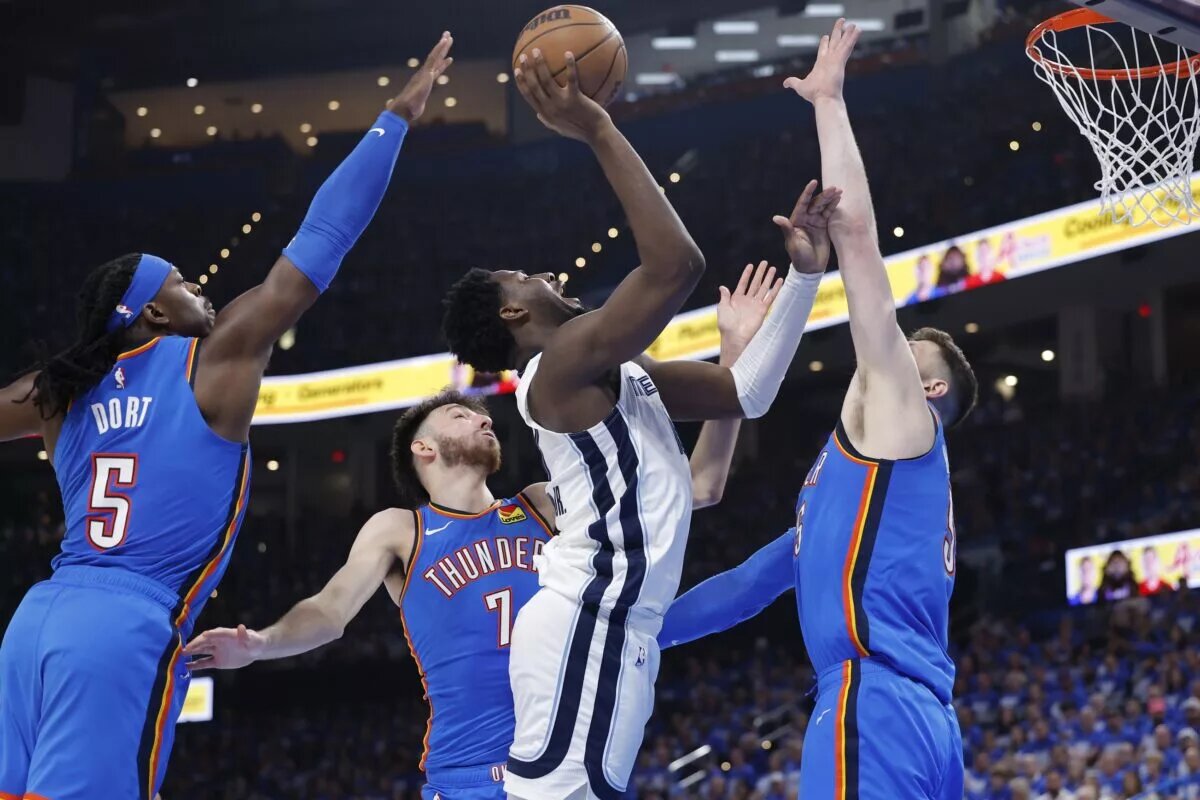 Apr 22, 2025; Oklahoma City, Oklahoma, USA; Memphis Grizzlies forward Jaren Jackson Jr. (13) shoots between Oklahoma City Thunder guard Luguentz Dort (5), forward Chet Holmgren (7), and center Isaiah Hartenstein (55) in the third quarter during game two of first round for the 2024 NBA Playoffs at Paycom Center. Mandatory Credit: Alonzo Adams-Imagn Images