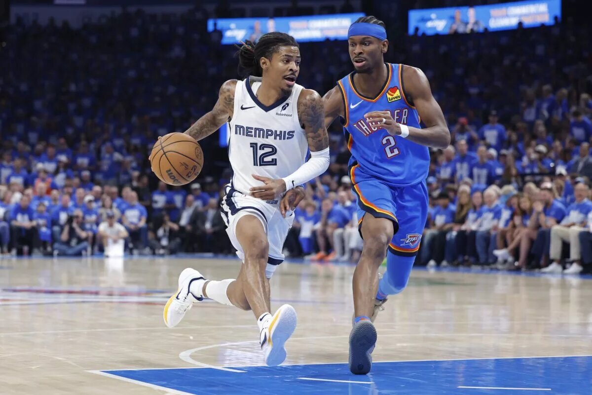 Apr 22, 2025; Oklahoma City, Oklahoma, USA; Memphis Grizzlies guard Ja Morant (12) drives to the basket beside Oklahoma City Thunder guard Shai Gilgeous-Alexander (2) in the third quarter during game two of first round for the 2024 NBA Playoffs at Paycom Center. Mandatory Credit: Alonzo Adams-Imagn Images