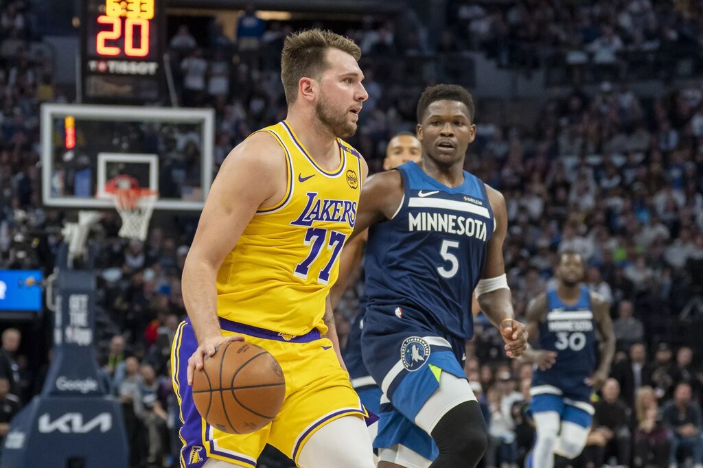 Apr 25, 2025; Minneapolis, Minnesota, USA; Los Angeles Lakers guard Luka Doncic (77) dribbles the ball against the Minnesota Timberwolves during game three of first round for the 2024 NBA Playoffs at Target Center. Mandatory Credit: Jesse Johnson-Imagn Images