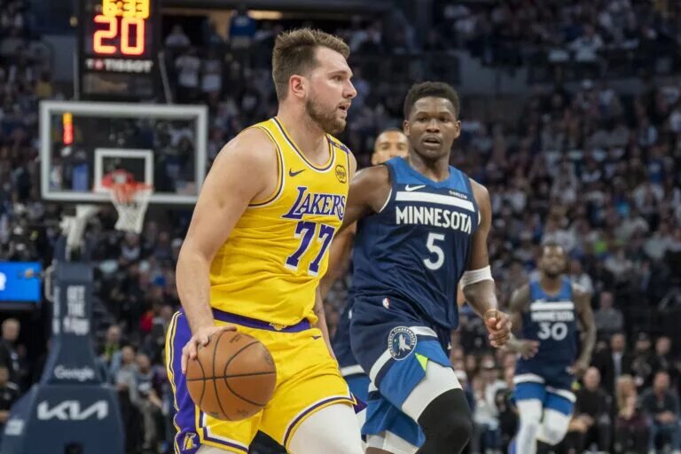 Apr 25, 2025; Minneapolis, Minnesota, USA; Los Angeles Lakers guard Luka Doncic (77) dribbles the ball against the Minnesota Timberwolves during game three of first round for the 2024 NBA Playoffs at Target Center. Mandatory Credit: Jesse Johnson-Imagn Images