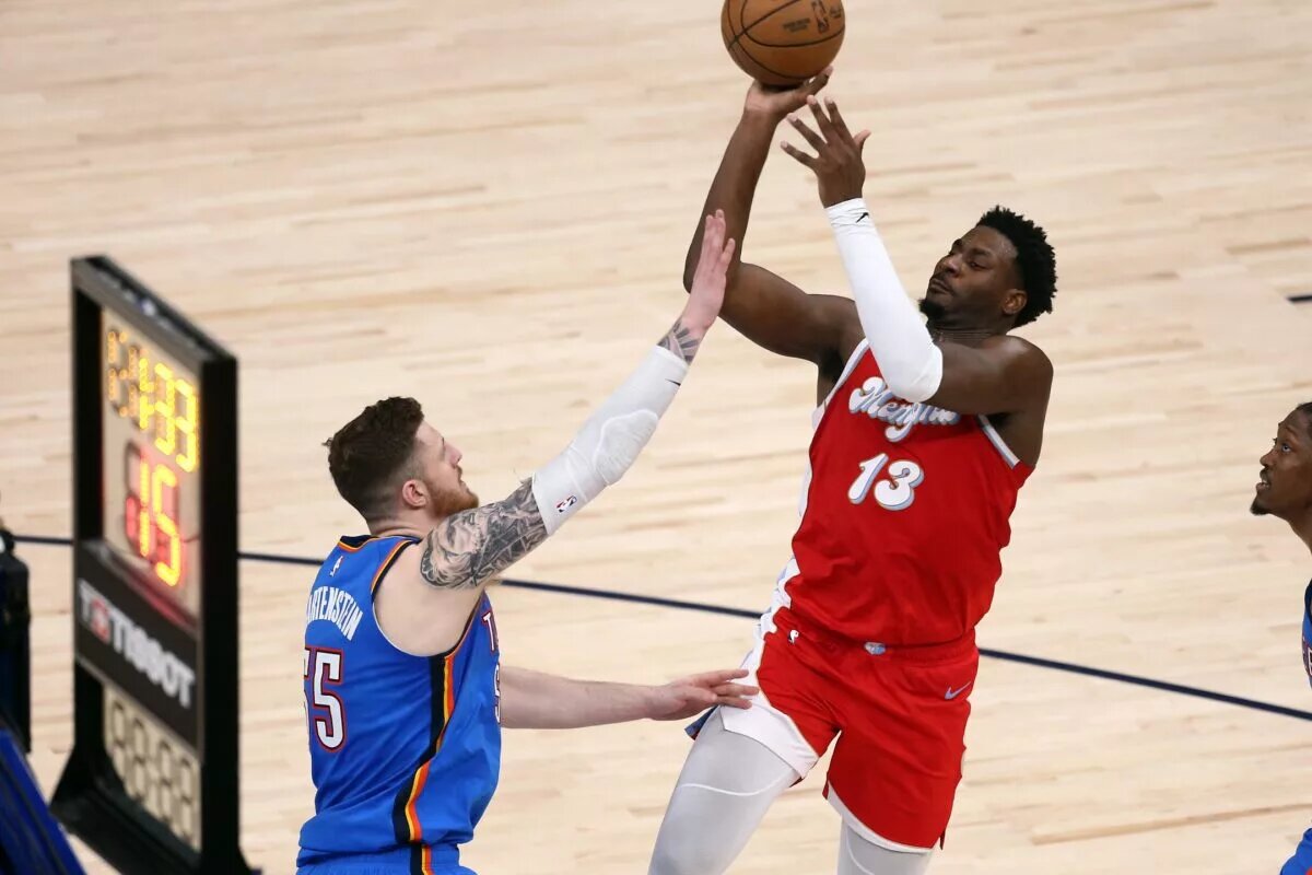 Apr 26, 2025; Memphis, Tennessee, USA; Memphis Grizzlies forward Jaren Jackson Jr. (13) shoots as Oklahoma City Thunder center Isaiah Hartenstein (55) defends during the second quarter during game four for the first round of the 2024 NBA Playoffs at FedExForum. Mandatory Credit: Petre Thomas-Imagn Images