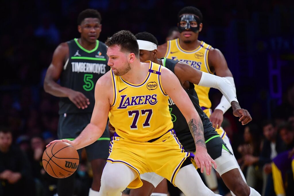 Apr 30, 2025; Los Angeles, California, USA; Los Angeles Lakers guard Luka Doncic (77) controls the ball against the Minnesota Timberwolves during the second half in game five of first round for the 2025 NBA Playoffs at Crypto.com Arena. Mandatory Credit: Gary A. Vasquez-Imagn Images