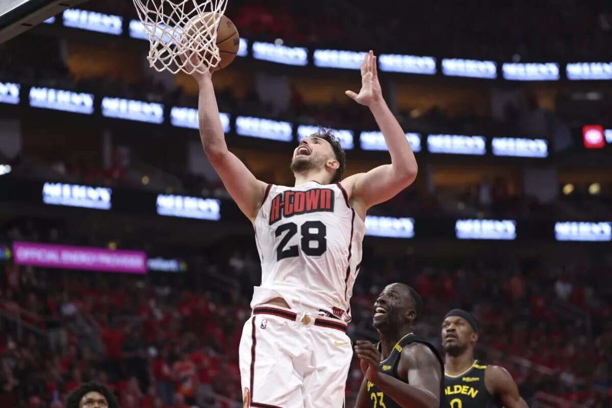 May 4, 2025; Houston, Texas, USA; Houston Rockets center Alperen Sengun (28) shoots the ball as Golden State Warriors forward Draymond Green (23) defends during game seven of the first round for the 2025 NBA Playoffs at Toyota Center. Mandatory Credit: Troy Taormina-Imagn Images