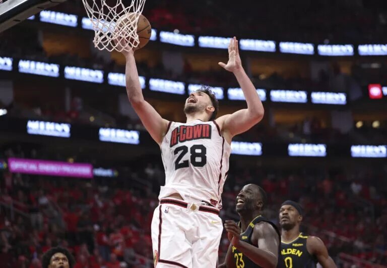 May 4, 2025; Houston, Texas, USA; Houston Rockets center Alperen Sengun (28) shoots the ball as Golden State Warriors forward Draymond Green (23) defends during game seven of the first round for the 2025 NBA Playoffs at Toyota Center. Mandatory Credit: Troy Taormina-Imagn Images