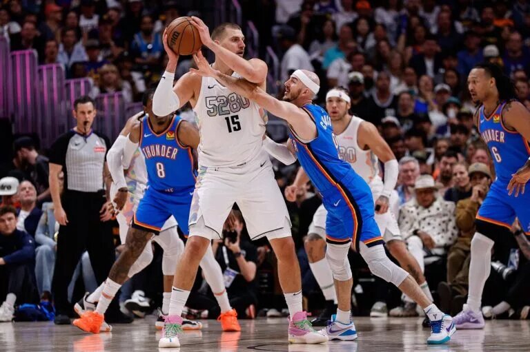 May 15, 2025; Denver, Colorado, USA; Denver Nuggets center Nikola Jokic (15) controls the ball under pressure form Oklahoma City Thunder guard Alex Caruso (9) in the second quarter during game six of the second round for the 2025 NBA Playoffs at Ball Arena. Mandatory Credit: Isaiah J. Downing-Imagn Images