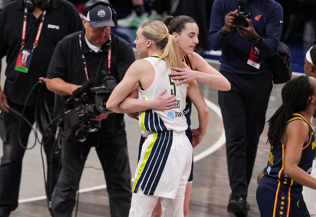 Indiana Fever guard Caitlin Clark (22) and Dallas Wings guard Paige Bueckers (5) hug Sunday, July 13, 2025, ahead of the game at Gainbridge Fieldhouse in Indianapolis. © Grace Hollars/IndyStar / USA TODAY NETWORK via Imagn Images