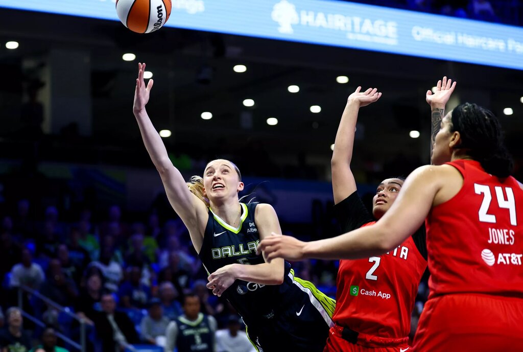 Jul 30, 2025; Arlington, Texas, USA; Dallas Wings guard Paige Bueckers (5) scores past Atlanta Dream guard Te-Hina Paopao (2) and Atlanta Dream forward Brionna Jones (24) during the second half at College Park Center. Mandatory Credit: Kevin Jairaj-Imagn Images