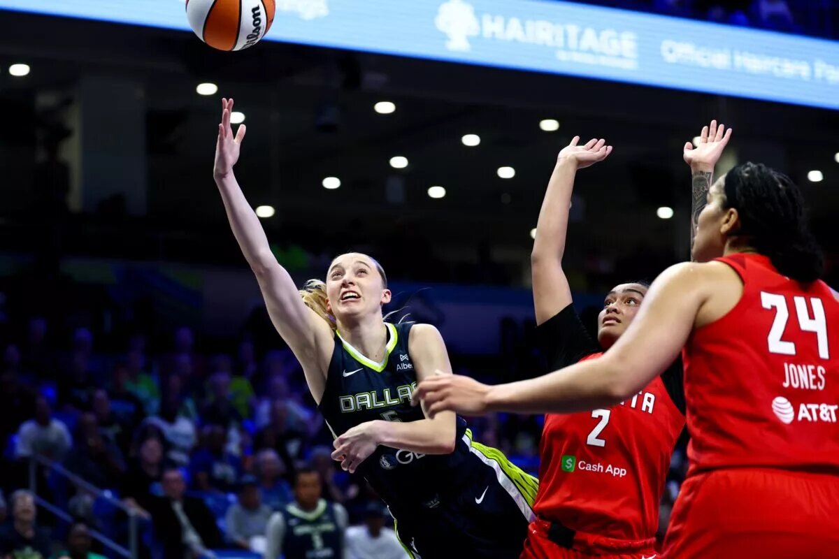 Jul 30, 2025; Arlington, Texas, USA; Dallas Wings guard Paige Bueckers (5) scores past Atlanta Dream guard Te-Hina Paopao (2) and Atlanta Dream forward Brionna Jones (24) during the second half at College Park Center. Mandatory Credit: Kevin Jairaj-Imagn Images