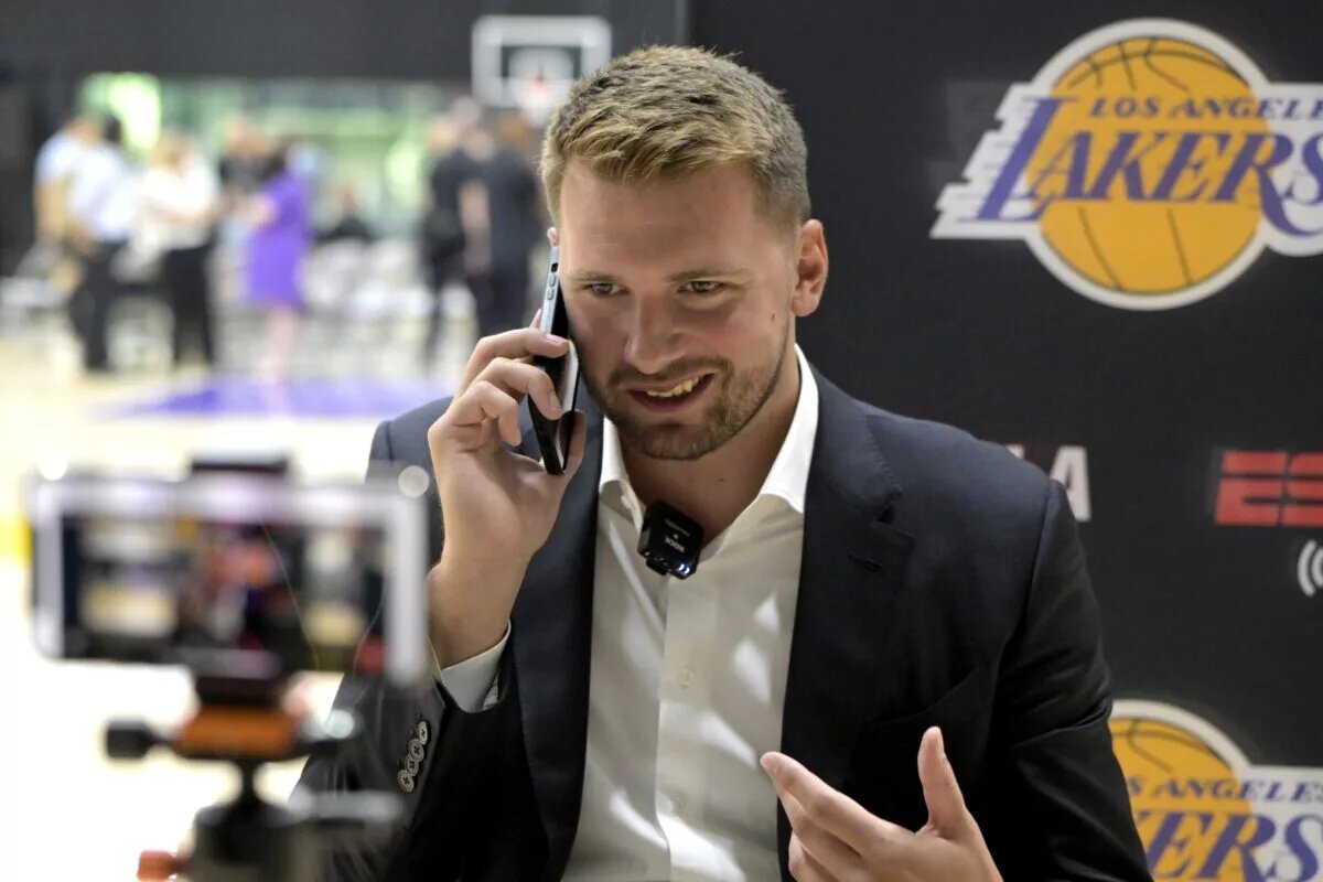 Aug 2, 2025; El Segundo, CA, USA; Los Angeles Lakers Luka Doncic (77) is interviewed by ESPN LA radio following a press conference announcing the signing of a 3-year, $165 million contract extension at UCLA Health Training Center. Mandatory Credit: Jayne Kamin-Oncea-Imagn Images