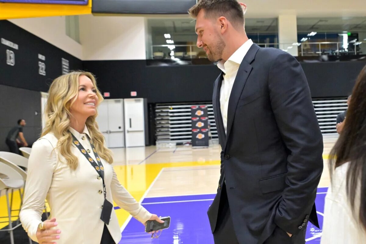 Aug 2, 2025; El Segundo, CA, USA; Los Angeles Lakers Luka Doncic (77) talks with team co-owner Jeanie Buss following a press conference announcing the signing of a 3-year, $165 million contract extension at UCLA Health Training Center. Mandatory Credit: Jayne Kamin-Oncea-Imagn Images