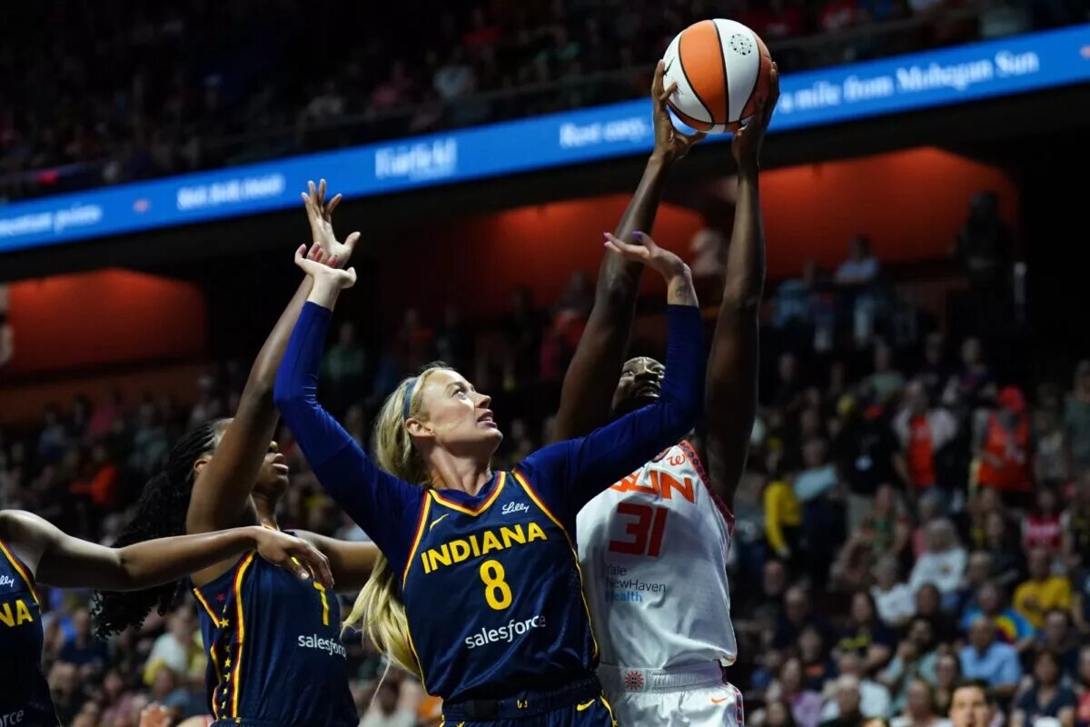 Aug 17, 2025; Uncasville, Connecticut, USA; Connecticut Sun center Tina Charles (31) and Indiana Fever guard Sophie Cunningham (8) work for the ball in the first half at Mohegan Sun Arena. Mandatory Credit: David Butler II-Imagn Images