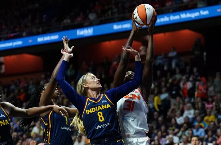 Aug 17, 2025; Uncasville, Connecticut, USA; Connecticut Sun center Tina Charles (31) and Indiana Fever guard Sophie Cunningham (8) work for the ball in the first half at Mohegan Sun Arena. Mandatory Credit: David Butler II-Imagn Images