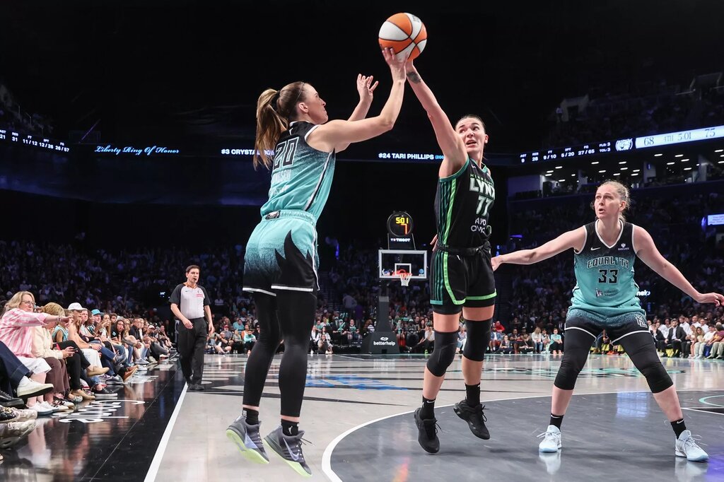 Aug 19, 2025; Brooklyn, New York, USA; Minnesota Lynx forward Maria Kliundikova (77) attempts to block a three point shot attempt by New York Liberty guard Sabrina Ionescu (20) in the fourth quarter at Barclays Center. Mandatory Credit: Wendell Cruz-Imagn Images