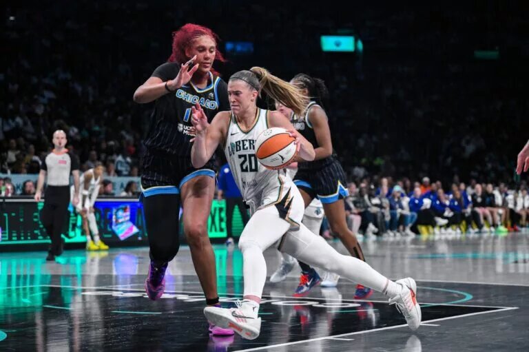 Aug 21, 2025; Brooklyn, New York, USA; New York Liberty guard Sabrina Ionescu (20) tries to drive past Chicago Sky center Kamilla Cardoso (10) during the second half at Barclays Center. Mandatory Credit: John Jones-Imagn Images