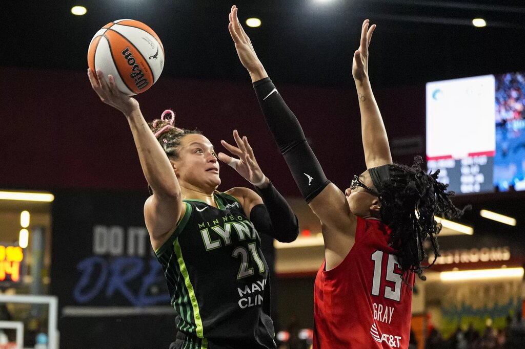 Aug 21, 2025; College Park, Georgia, USA; Minnesota Lynx guard Kayla McBride (21) tries to shoot against Atlanta Dream guard Allisha Gray (15) during the second half at Gateway Center Arena at College Park. Mandatory Credit: Dale Zanine-Imagn Images