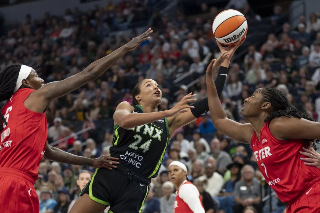 Aug 24, 2025; Minneapolis, Minnesota, USA; Minnesota Lynx forward Napheesa Collier (24) drives to the basket and shoots the ball past Indiana Fever forward Natasha Howard (6) and Indiana Fever forward Aliyah Boston (7) in the first half at Target Center. Mandatory Credit: Jesse Johnson-Imagn Images