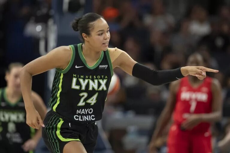 Aug 24, 2025; Minneapolis, Minnesota, USA; Minnesota Lynx forward Napheesa Collier (24) points to the bench after making a three point shot against the Indiana Fever in the second half at Target Center. Mandatory Credit: Jesse Johnson-Imagn Images
