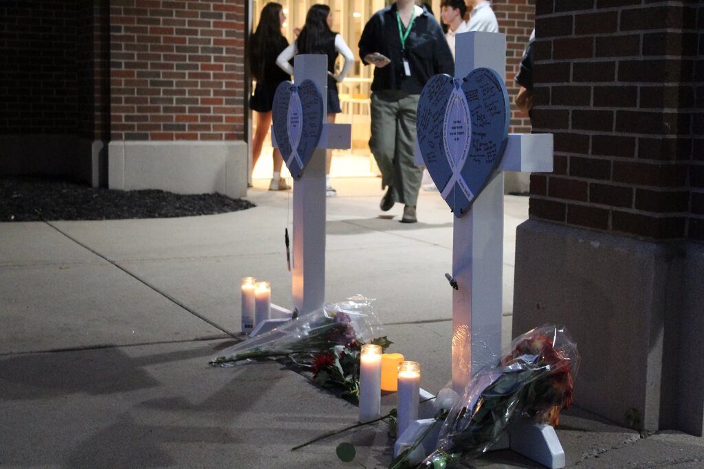 Vigil attendees wrote messages on crosses for the two children who died in the Aug. 27 Annunciation Church shooting in Minneapolis. © Corey Schmidt / St. Cloud Times / USA TODAY NETWORK via Imagn Images
