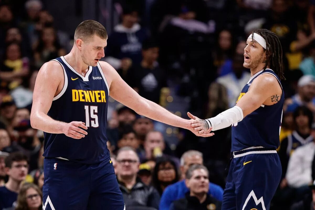 Denver Nuggets center Nikola Jokic (15) reacts with forward Aaron Gordon
