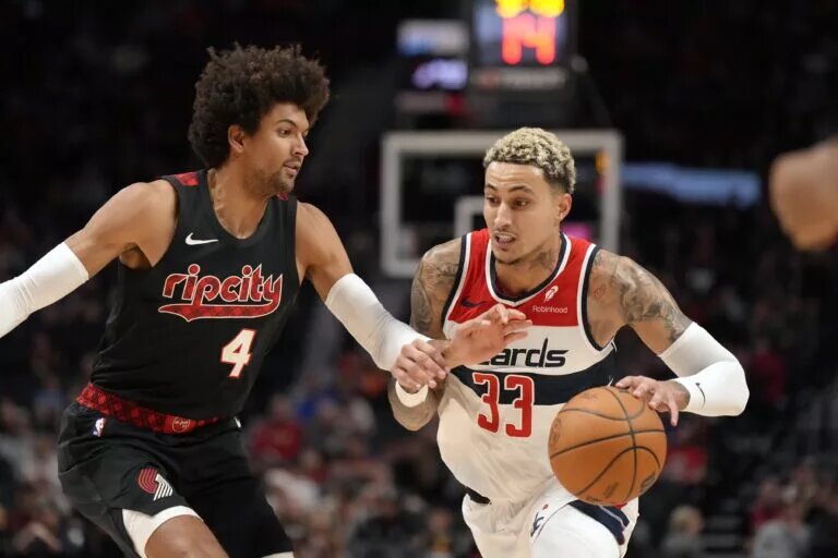 Dec 21, 2023; Portland, Oregon, USA; Washington Wizards small forward Kyle Kuzma (33) dribbles the ball as Portland Trail Blazers shooting guard Matisse Thybulle (4) defends during the first half at Moda Center. Mandatory Credit: Soobum Im-USA TODAY Sports
