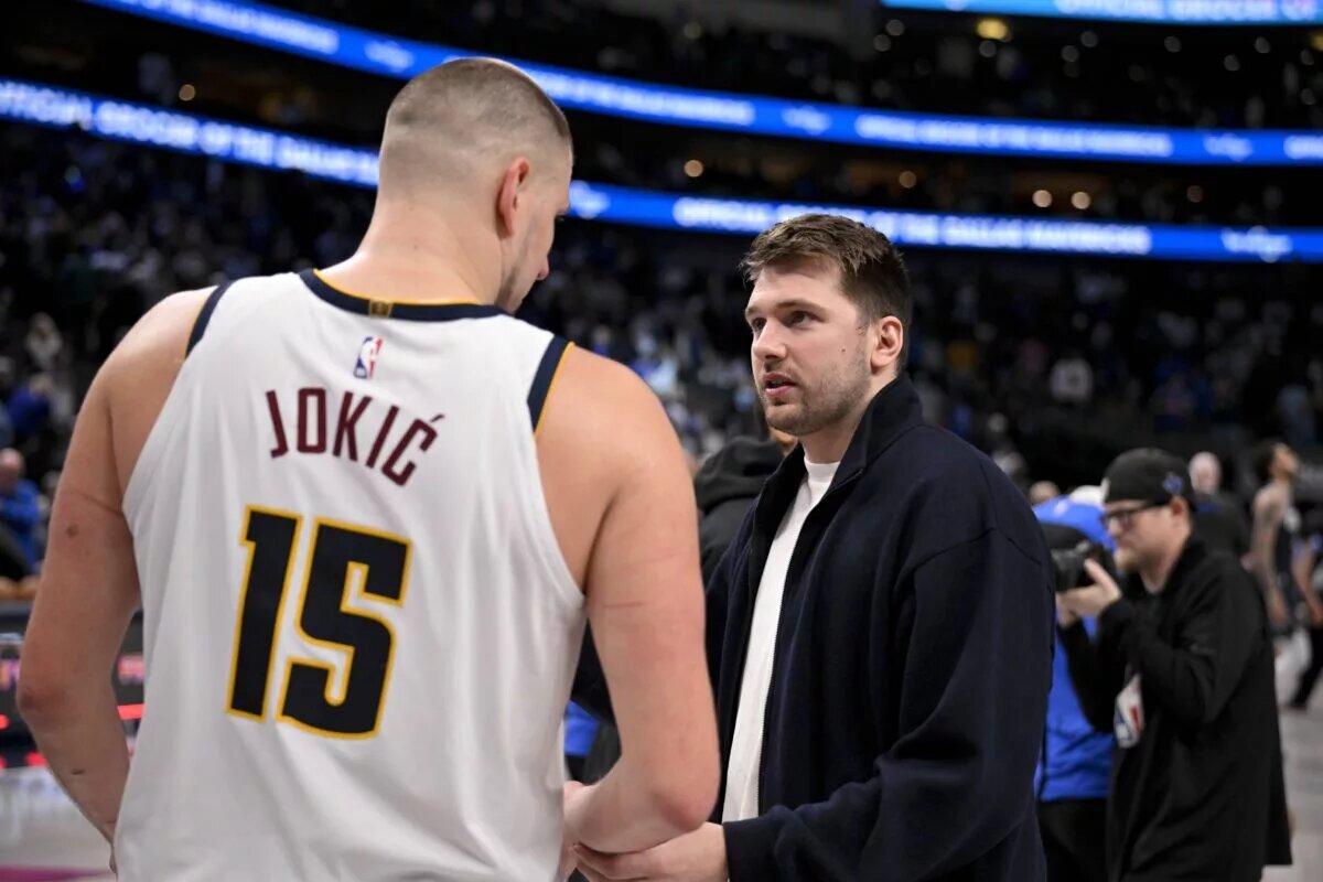 Jan 12, 2025; Dallas, Texas, USA; Dallas Mavericks guard Luka Doncic (right) talks with Denver Nuggets center Nikola Jokic (left) after the game at the American Airlines Center. Mandatory Credit: Jerome Miron-Imagn Images