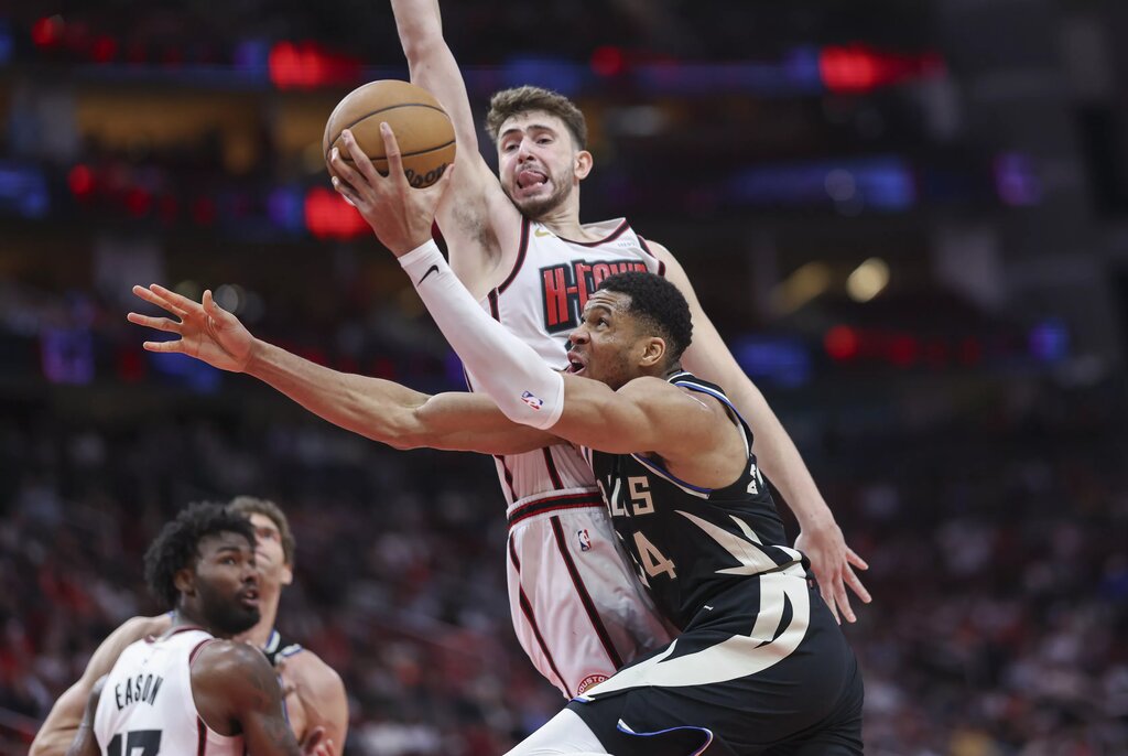 Houston Rockets center Alperen Sengun guards Milwaukee Bucks forward Giannis Antetokounmpo