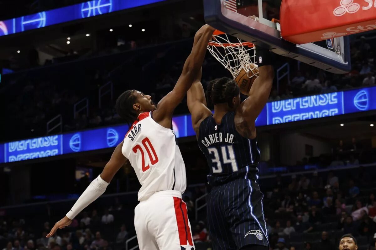 Apr 3, 2025; Washington, District of Columbia, USA; Orlando Magic center Wendell Carter Jr. (34) dunks the ball as Washington Wizards forward Alex Sarr (20) defends in the first half at Capital One Arena. Mandatory Credit: Geoff Burke-Imagn Images