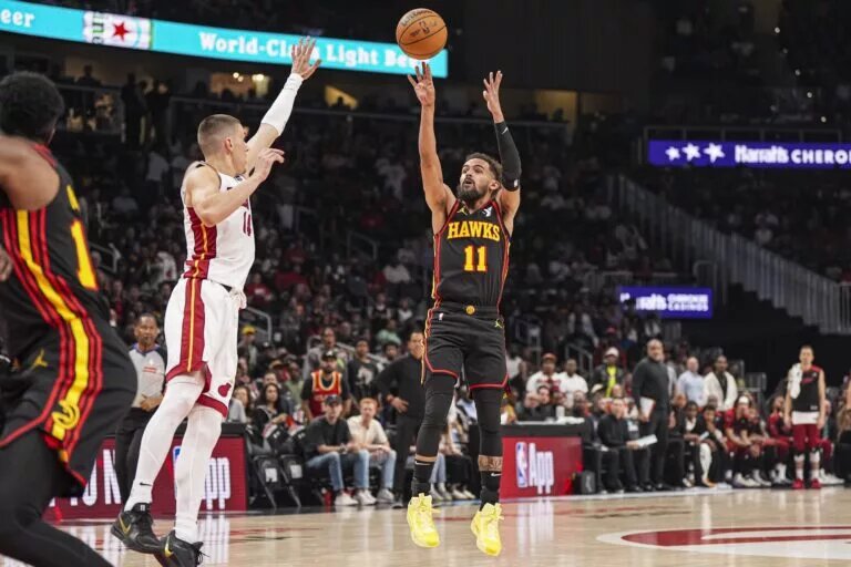 Apr 18, 2025; Atlanta, Georgia, USA; Atlanta Hawks guard Trae Young (11) shoots over Miami Heat guard Tyler Herro (14) during the first half at State Farm Arena. Mandatory Credit: Dale Zanine-Imagn Images