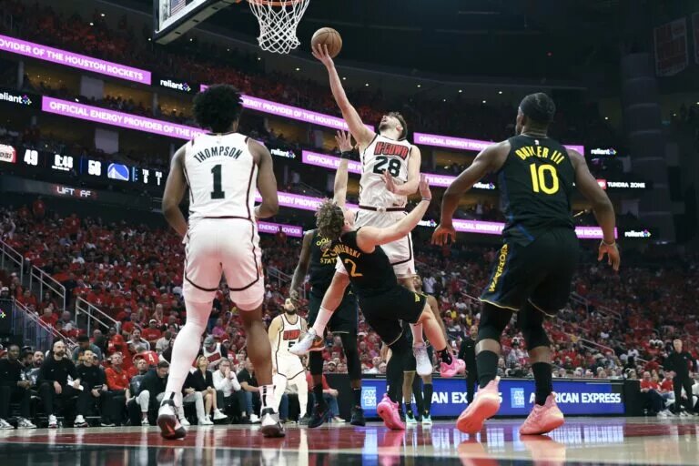 Houston Rockets center Alperen Sengun scores on the Golden State Warriors as teammate Amen Thompson looks on