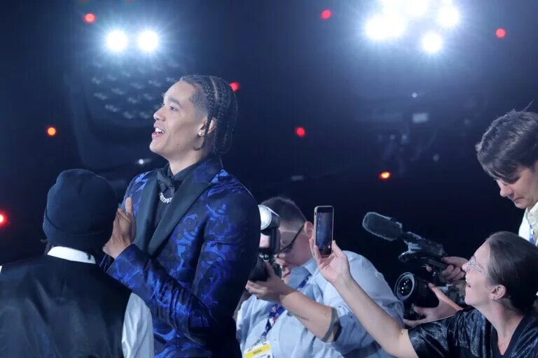 Jun 25, 2025; Brooklyn, NY, USA; Yanic Konan Niederhauser walks on stage after being selected as the 30th pick by the Los Angeles Clippers in the first round of the 2025 NBA Draft at Barclays Center. Mandatory Credit: Brad Penner-Imagn Images