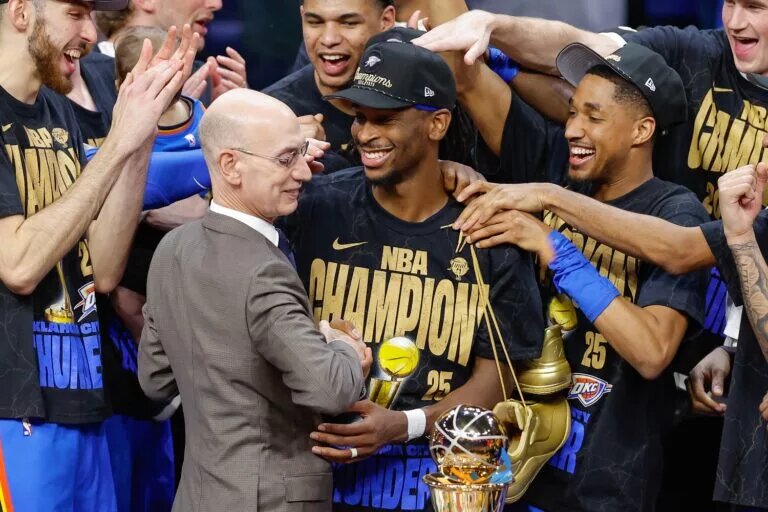 Oklahoma City Thunder guard Shai Gilgeous-Alexander (2) hugs NBA Commissioner Adam Silver at the end of game seven of the 2025 NBA Finals after defeating the Indiana Pacers at Paycom Center.