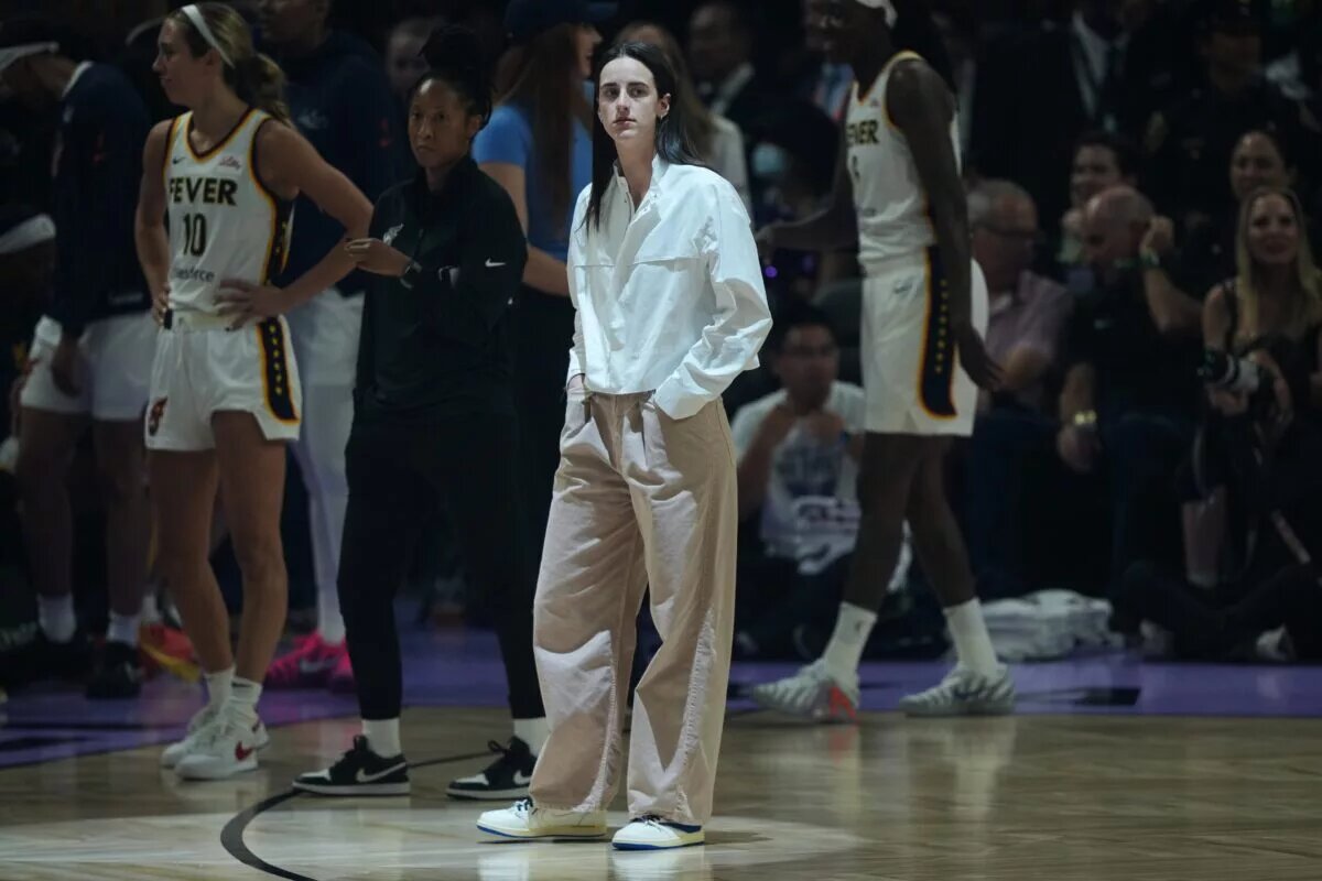 Indiana Fever guard Caitlin Clark (center) stands on the court before the game against the Golden State Valkyries at Chase Center.
