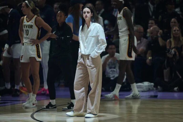 Indiana Fever guard Caitlin Clark (center) stands on the court before the game against the Golden State Valkyries at Chase Center.