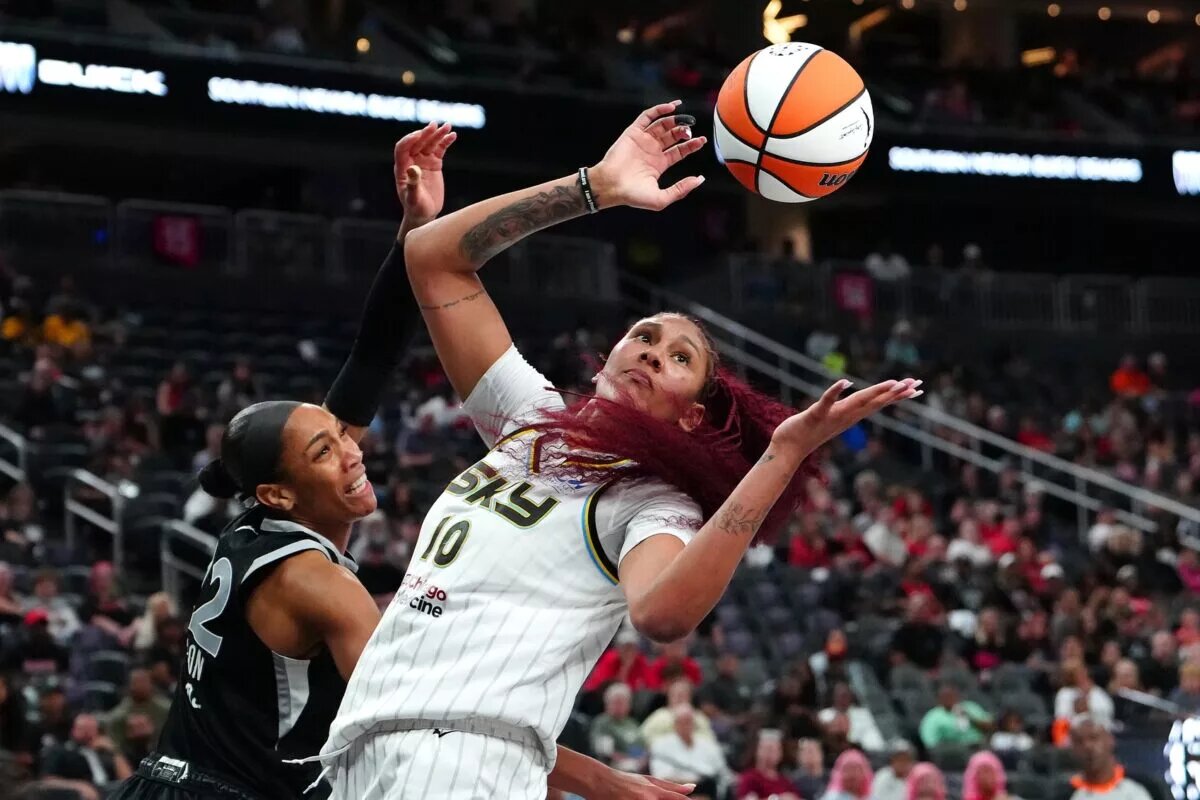 Sep 9, 2025; Las Vegas, Nevada, USA; Chicago Sky center Kamilla Cardoso (10) looks to grab a loose ball after blocking a shot attempt by Las Vegas Aces center A'ja Wilson (22) during the third quarter at T-Mobile Arena. Mandatory Credit: Stephen R. Sylvanie-Imagn Images