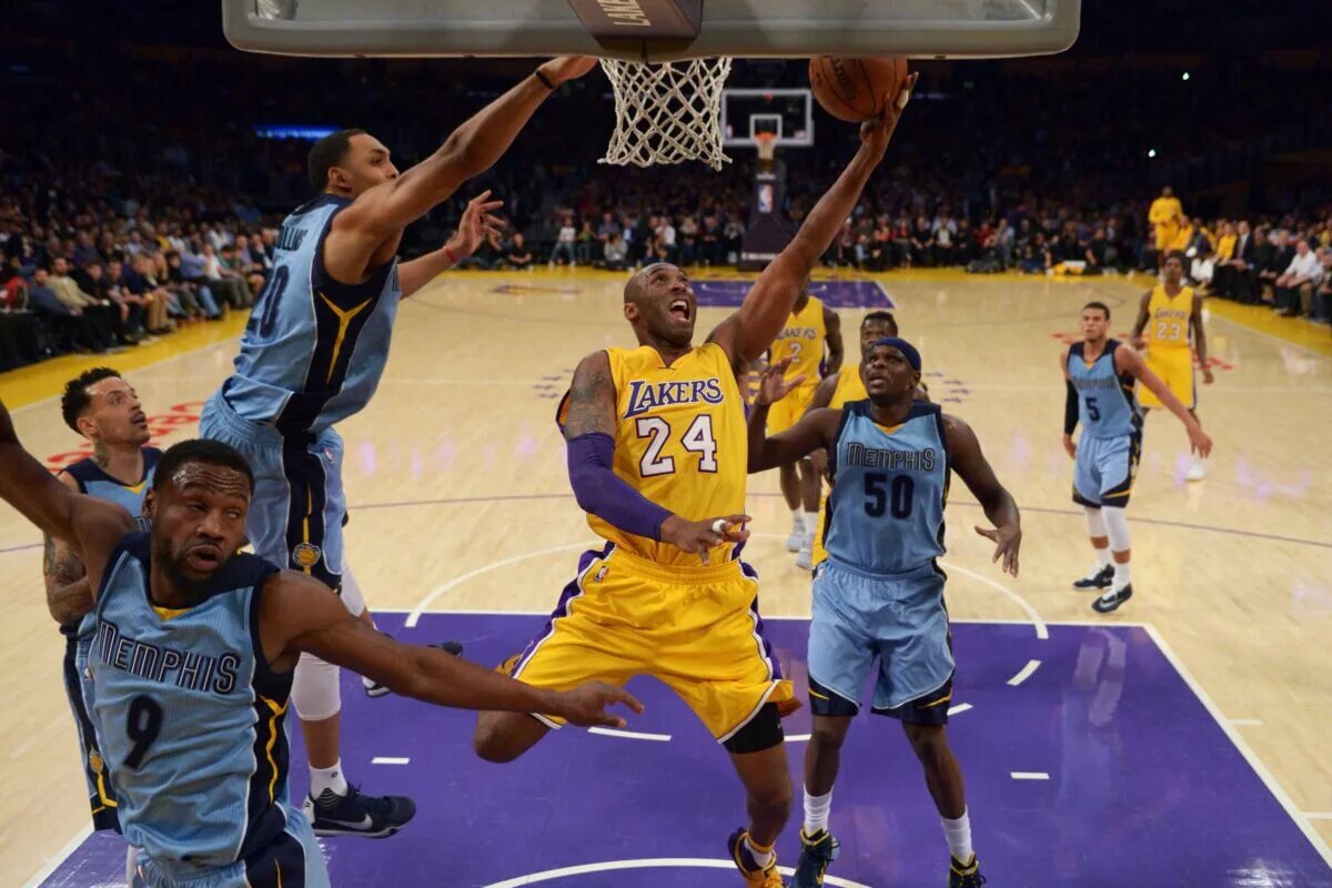 Mar 22, 2016; Los Angeles, CA, USA; Los Angeles Lakers forward Kobe Bryant (24) shoots the ball while defended by Memphis Grizzlies guard Tony Allen (9), center Ryan Hollins (20) and forward Zach Randolph (50) during an NBA game at Staples Center. The Lakers defeated the Grizzlies 107-100. Mandatory Credit: Kirby Lee-USA TODAY Sports