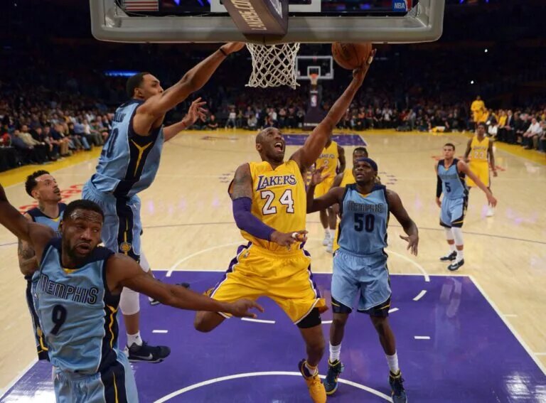 Mar 22, 2016; Los Angeles, CA, USA; Los Angeles Lakers forward Kobe Bryant (24) shoots the ball while defended by Memphis Grizzlies guard Tony Allen (9), center Ryan Hollins (20) and forward Zach Randolph (50) during an NBA game at Staples Center. The Lakers defeated the Grizzlies 107-100. Mandatory Credit: Kirby Lee-USA TODAY Sports