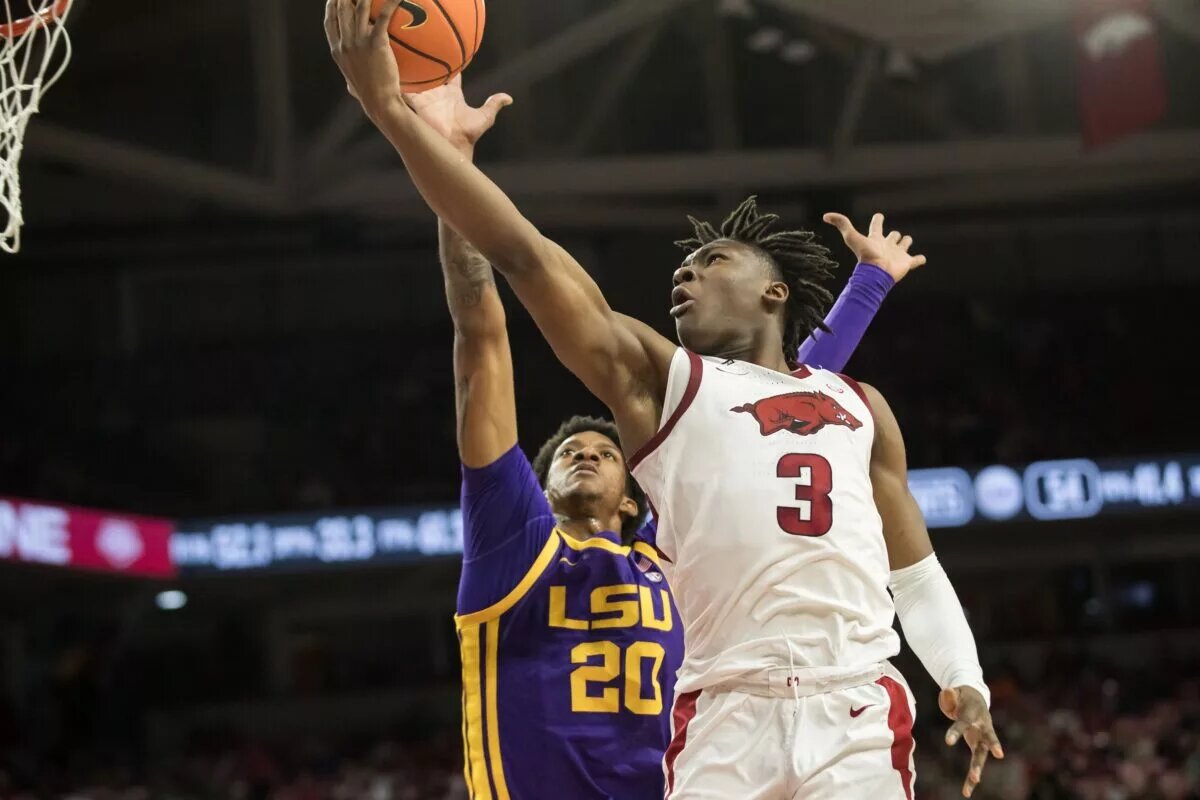 Feb 12, 2025; Fayetteville, Arkansas, USA; Arkansas Razorbacks forward Adou Thiero (3) goes for a layup past LSU Tigers forward Derek Fountain (20) during the second half at Bud Walton Arena. Arkansas won 70-58. Mandatory Credit: Brett Rojo-Imagn Images