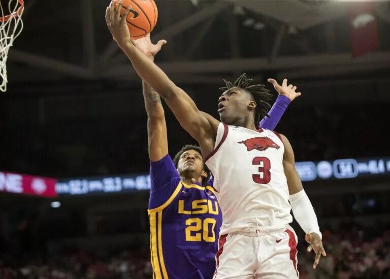 Feb 12, 2025; Fayetteville, Arkansas, USA; Arkansas Razorbacks forward Adou Thiero (3) goes for a layup past LSU Tigers forward Derek Fountain (20) during the second half at Bud Walton Arena. Arkansas won 70-58. Mandatory Credit: Brett Rojo-Imagn Images