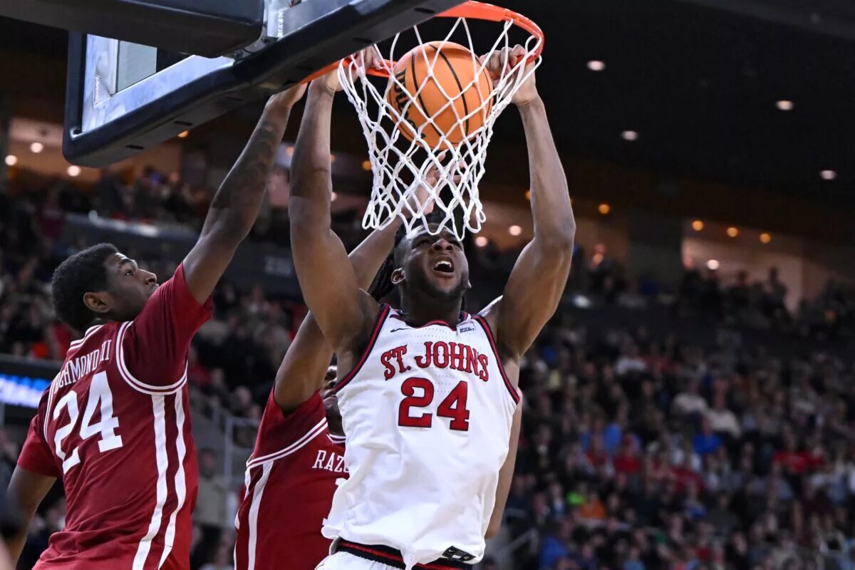 Mar 22, 2025; Providence, RI, USA; St. John's Red Storm forward Zuby Ejiofor (24) dunks against Arkansas Razorbacks forward Billy Richmond III (24) and guard Johnell Davis (1) during the second half of a second round men’s NCAA Tournament game at Amica Mutual Pavilion. Mandatory Credit: Brian Fluharty-Imagn Images