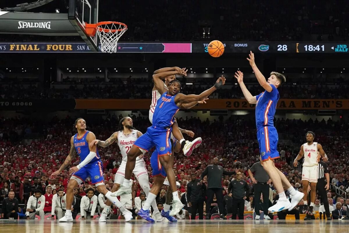 Apr 7, 2025; San Antonio, TX, USA; Florida Gators forwards Rueben Chinyelu (9) and Alex Condon (21) reach for a rebound during the national championship of the men's 2025 NCAA tournament against the Houston Cougars at Alamodome. Mandatory Credit: Scott Wachter-Imagn Images