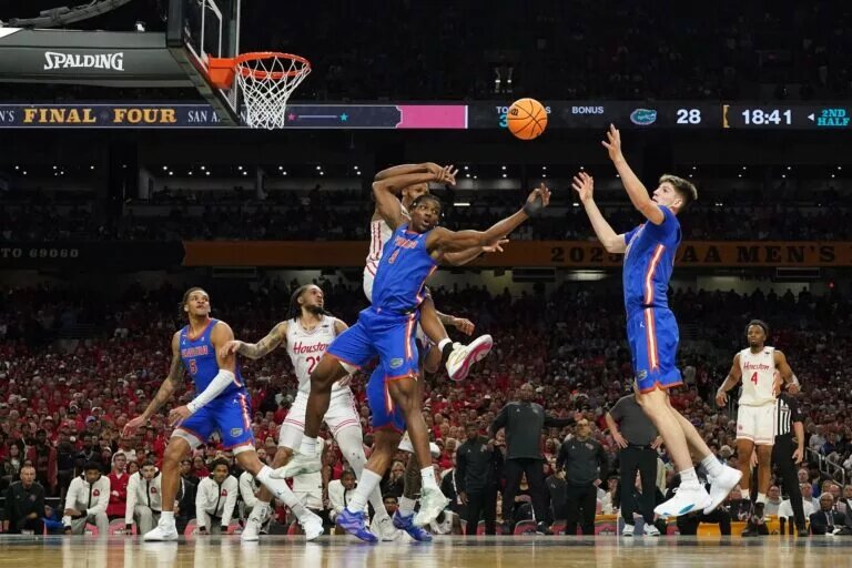 Apr 7, 2025; San Antonio, TX, USA; Florida Gators forwards Rueben Chinyelu (9) and Alex Condon (21) reach for a rebound during the national championship of the men's 2025 NCAA tournament against the Houston Cougars at Alamodome. Mandatory Credit: Scott Wachter-Imagn Images