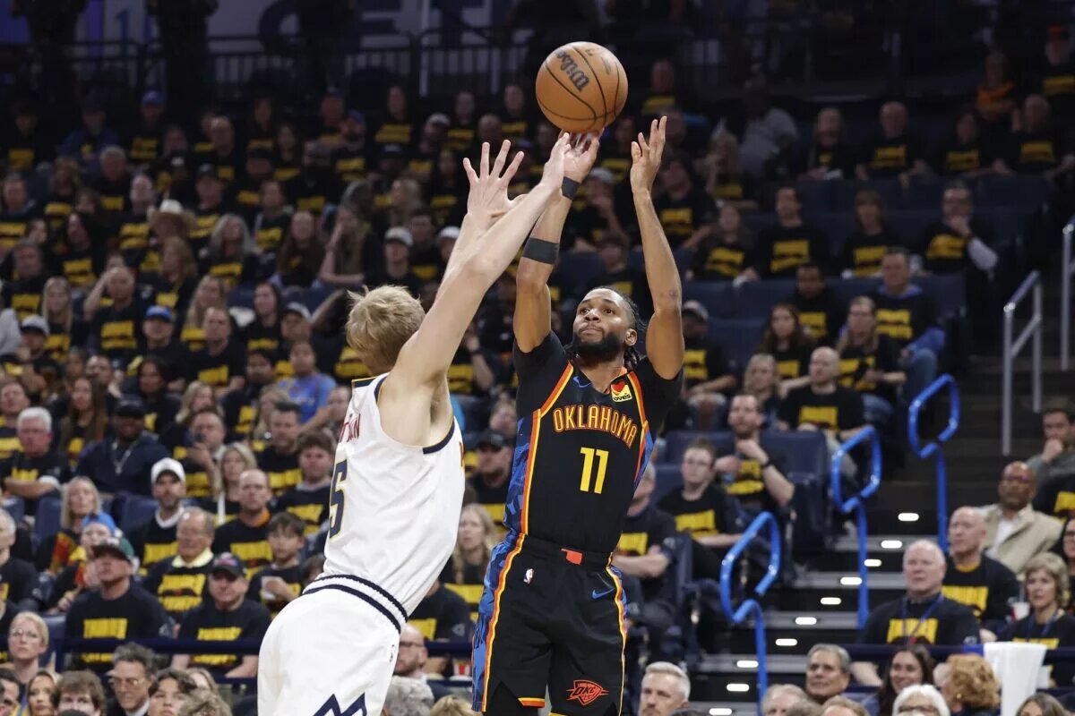 May 7, 2025; Oklahoma City, Oklahoma, USA; Oklahoma City Thunder guard Isaiah Joe (11) shoots a three point basket over Denver Nuggets forward Hunter Tyson (5) in the second half during game two of the second round for the 2025 NBA Playoffs at Paycom Center. Mandatory Credit: Alonzo Adams-Imagn Images