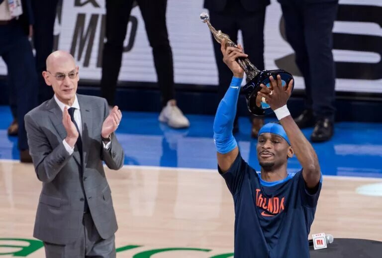May 22, 2025; Oklahoma City, Oklahoma, USA; NBA commissioner is Adam Silver presents Oklahoma City Thunder guard Shai Gilgeous-Alexander (2) with the Michael Jordan Trophy for winning the most valuable player award for the 2024-25 season before game two of the western conference finals for the 2025 NBA Playoffs at Paycom Center. Mandatory Credit: Brett Rojo-Imagn Images