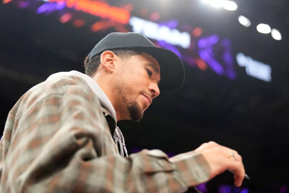 Sep 19, 2025; Phoenix, Arizona, USA; Phoenix Suns player Devin Booker attends the game between the Phoenix Mercury and the New York Liberty during the second half of game three of round one for the 2025 WNBA Playoffs at PHX Arena. Mandatory Credit: Joe Camporeale-Imagn Images