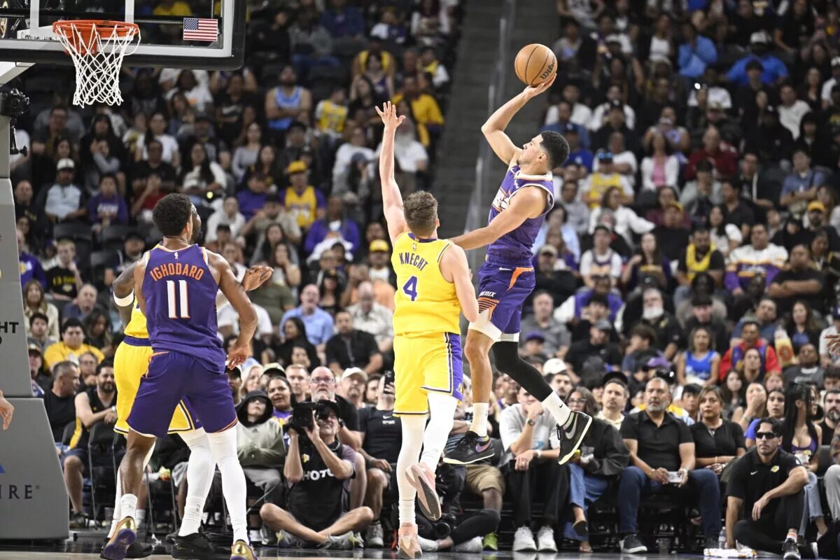 Oct 3, 2025; Palm Desert, California, USA; Phoenix Suns guard Devin Booker (1) shoots over Los Angeles Lakers guard Dalton Knecht (4) during the first half at Acrisure Arena. Mandatory Credit: Denis Poroy-Imagn Images