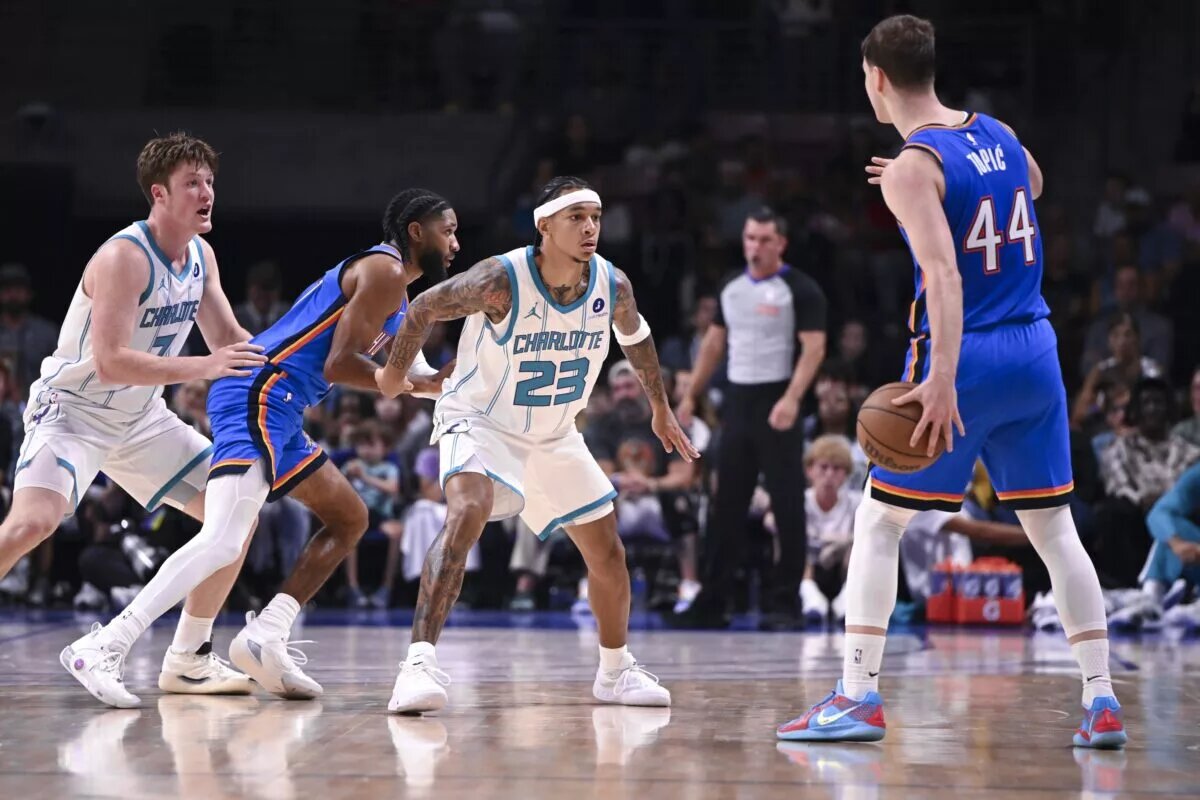 Charlotte Hornets guard Tre Mann (23) defends against Oklahoma City Thunder Nikola Topic (44)